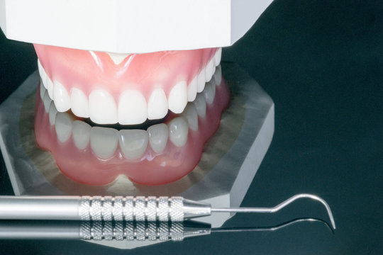 Close up , Complete denture or full denture on black background.