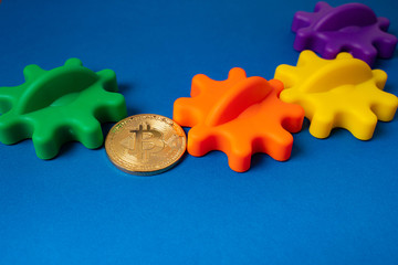 Bitcoin as a chain of links in gears on blue background.