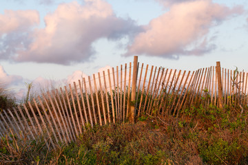 A typical wooden fence along the barrier sand dunes designed to keep tourists and children away from more dangerous sandy areas