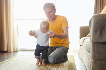 Father take toddler baby son to walk at home in holiday. Family, father, son, baby, Happy, lifestyle concept.