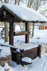 Snowy wooden well in winter season