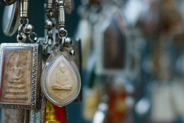 assortment of buddhist amulet sold in market in bangkok -Thailand