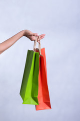 Shopping bags with red and green colors A woman's hand On a white background