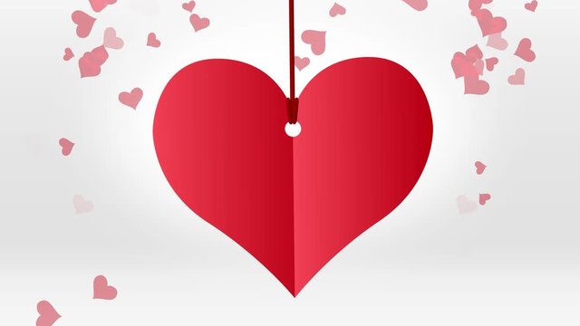 Red paper heart hanging on red string with red hearts particles on white background