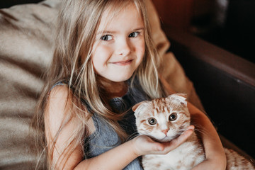 Girl at home with a cat, home comfort, family
