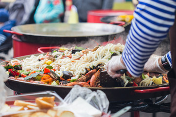 Fototapeta premium Spanish paella prepared in the street restaurant.