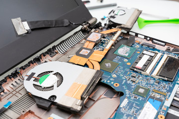 disassembled laptop with a dusty cooler and dried thermal grease. laptop before cleaning