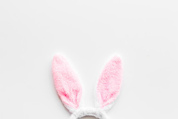 Easter bunny concept. Toy rabbit's ears on white background top-down copy space