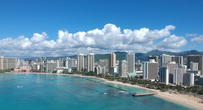 Waikiki Beach photo take from Diamond head showing all the hotels in Waikiki, Honolulu, Oahu, Hawaii and magnificent Waikiki beach in the main picture with so many tourists  and turquoise waters