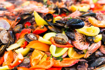 Street food and meal - Spanish paella close-up with shrimp and clams