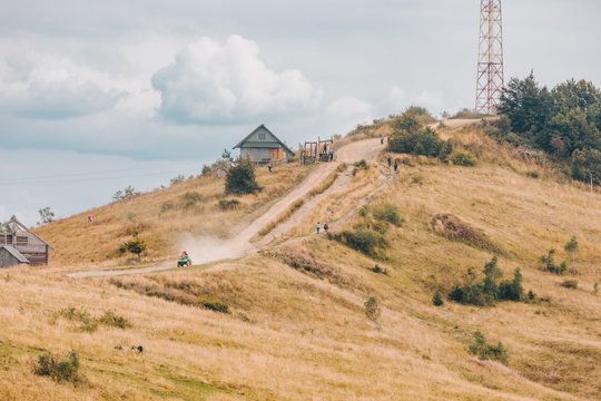 Zakhar Berkut, Ukraine - September 7, 2019: people riding on all terrain vehicle by mountains
