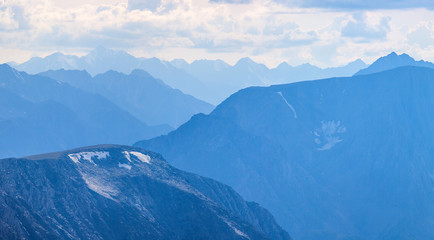 Mountain peaks in blue haze. Traveling in the mountains, trekking.