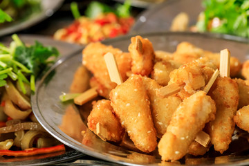 Delicious fried chicken skewers on a plate.