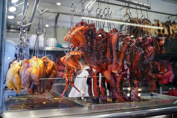 sale of roasted Peking duck and chicken suspended on the grill in a Chinese cafe