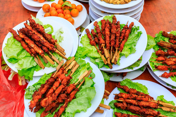 Delicious fried chicken skewers and lettuce on a plate