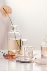 Bottles with different perfume oils on table