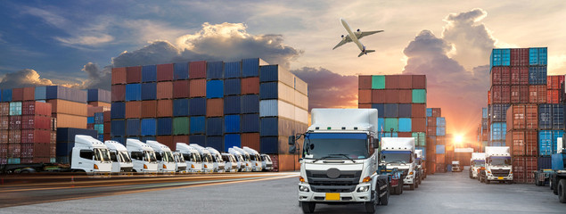 Container truck in ship port for business Logistics and transportation of Container Cargo ship and...