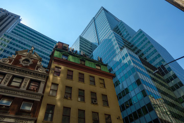 Fototapeta na wymiar Modern skyscrapers and old building on city street