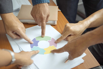 Business people join together to complete the puzzle