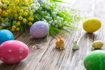 Obraz na płótnie Canvas Easter rabbit with Easter eggs on wooden background. Close-up.