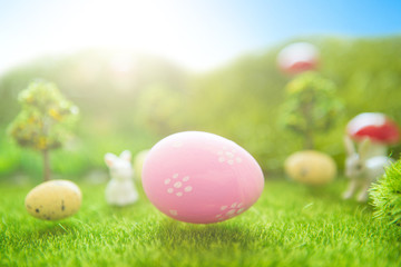 Fototapeta na wymiar Easter background with pink Easter eggs on green grass in pastel colors in spring of Dreamland or fairy world