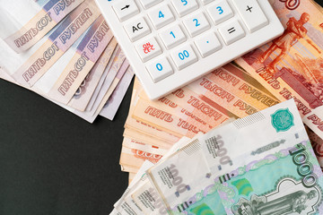 Close up photo of stack of Russian money rubles with calculator