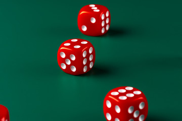 Red dice on green background close up