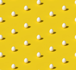 White eggs on bright yellow isometric seamless background