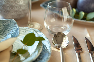 Silver cutlery on table top with tablecloth