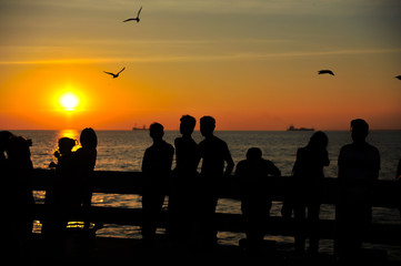 Fototapeta na wymiar Silhouette group of people at golden sunset time