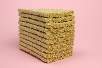 A stack of Crispbread on a pink background. Diet, proper nutrition, Vegan