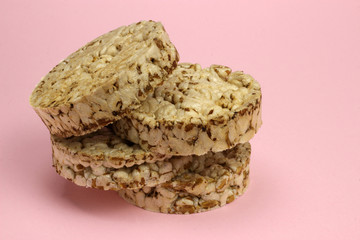 A stack of rice and buckwheat Crispbread on a pink background. Diet, proper nutrition, Vegan