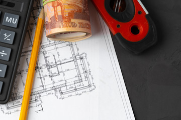 Russian roubles stack on blueprints wth calculator. Renovation, building expenses concept