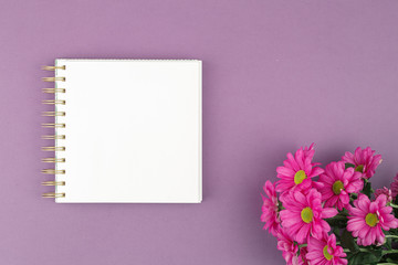 Top view of open notebook notepad with flowers.