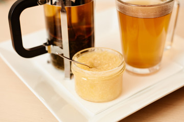 Tea with a teapot, cup and lemon jam. Natural fruit tea.