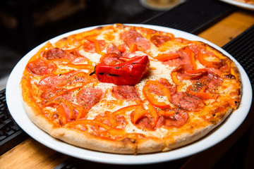 Hot pizza with salami and cheese.