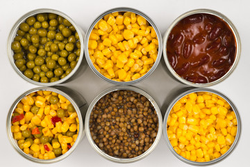 Canned food on white background. Green pea, beans, corn, lentils.