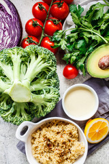 Ingredients for vegan salad with quinoa, broccoli, avocado and tahini dressing, top view. Healthy food concept.