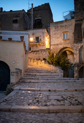 Fototapeta na wymiar Typical cobbled stairs in a side street alleyway iin the Sassi di Matera a historic district in the city of Matera. Basilicata. Italy