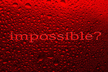 The inscription impossible on a red background with water drops.