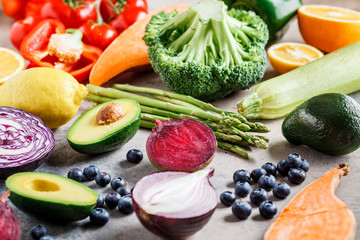 Rainbow colors vegetables and berries background. Detox, vegan food, ingredients for juice and salad.