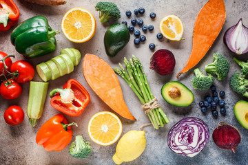 Rainbow colors vegetables and berries background, top view. Detox, vegan food, ingredients for juice and salad.