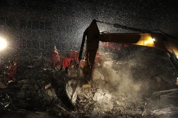 Rescue teams and excavator searching through the buildings destroyed during the earthquake. © IV. Murat
