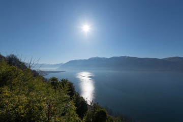 Alpine Lake with Mountain and Sunshine in Ticino, Switzerland.