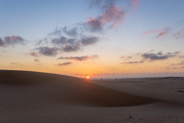 Obraz na płótnie Canvas Sand dunes in the National Park of Dunas de Corralejo during a beautiful sunset, Canary Islands - Fuerteventura
