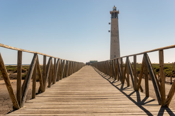 Obraz premium wooden jetty to the ocean and lighthouse, Morro Jable Beach - Fuerteventura