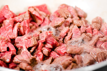 Pieces of fresh beef meat fried in a pan
