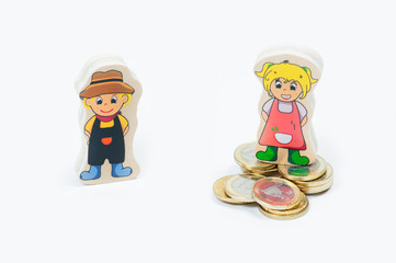 a toy figure of a woman on a large stack of one Euro coins and a toy figure of a man without coins on a white background