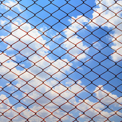 Metallic net on blue sky background