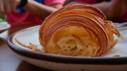 freshly baked croissants on white plate, top view